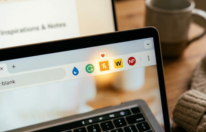 Team standup meeting looking at security audit report on TV screen